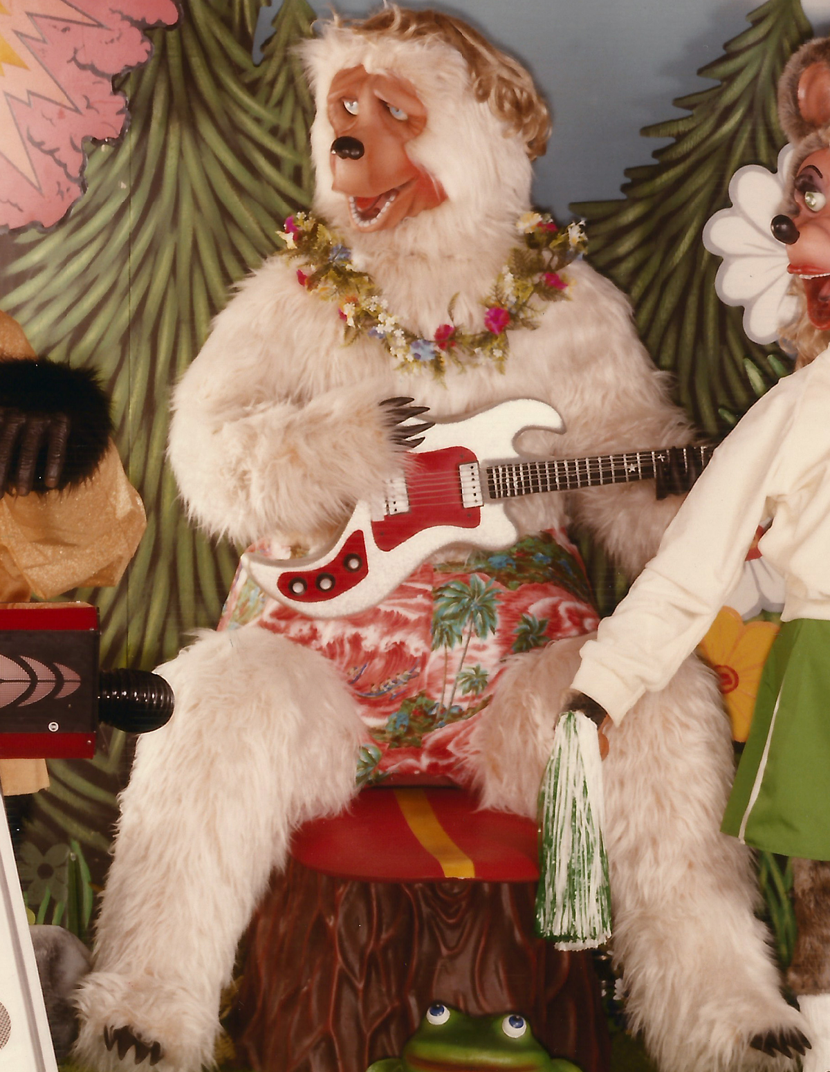 The Beach Bear animatronic. He is a polar bear in swim shorts, a lei, and a blonde wig, and he is holding a guitar.
