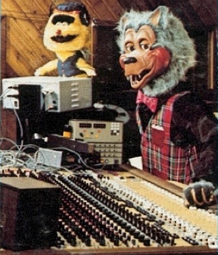 Rolfe and Earl animatronic in the creative engineering recording studio, wearing headphones.