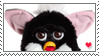 A black and white skunk furby with a small bouncing red heart.